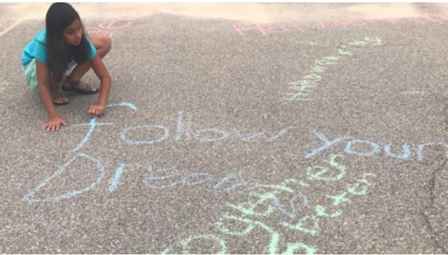 Kid Drawing on Pavement with Chalk