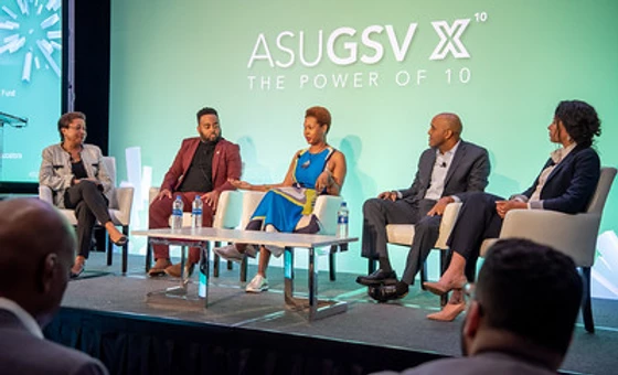 Five workforce leaders on stage in a conference setting